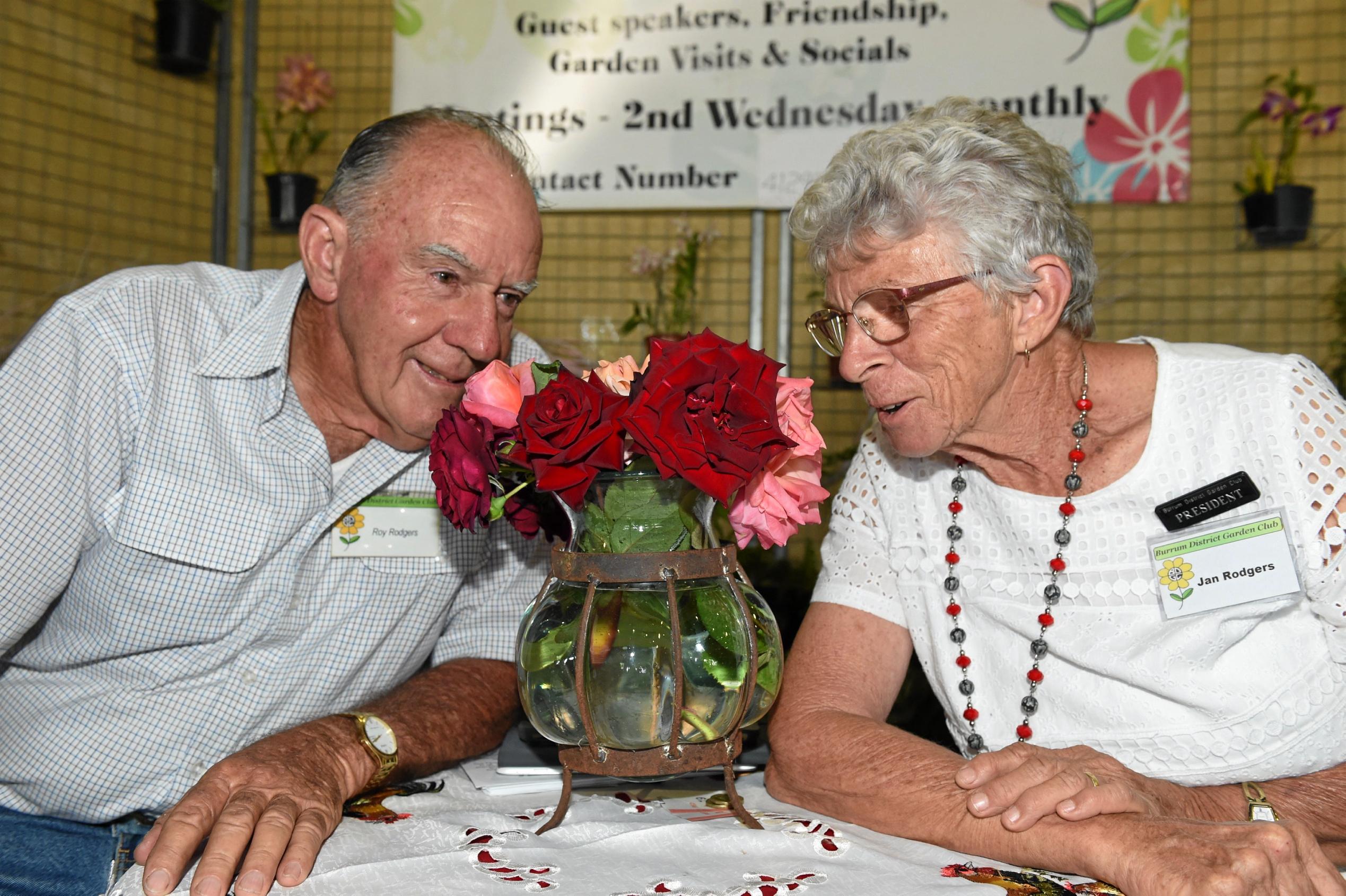 Hervey Bay Spring Orchid & Garden Spectacular - Roy and Jan rodgers from Burrum District Garden Club taking some time to smell the roses. Picture: Cody Fox