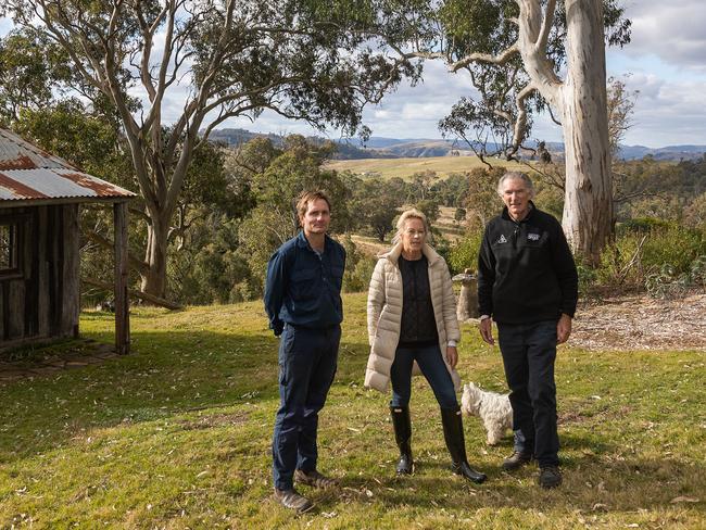 Left to right Chris Ainsworth with Charlotte Smith and her partner Keith Kerridge on their property at Bannaby NSW, the are one of the many owners who have lost the battle with Transgrid to prevent controversial transmission lines running through their land.