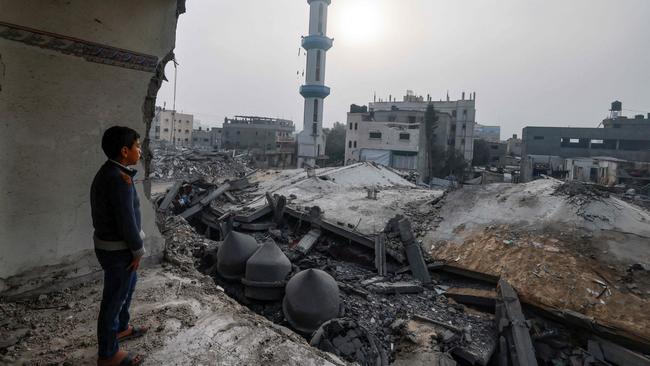 A child standing inside a damaged building, stares at the al-Faruq mosque, levelled by Israeli bombardment in Rafah in the southern Gaza Strip on Sunday. Picture: AFP