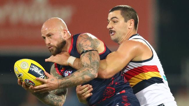 Taylor Walker heaps the pressure on Melbourne’s Nathan Jones. Picture: Scott Barbour/Getty Images