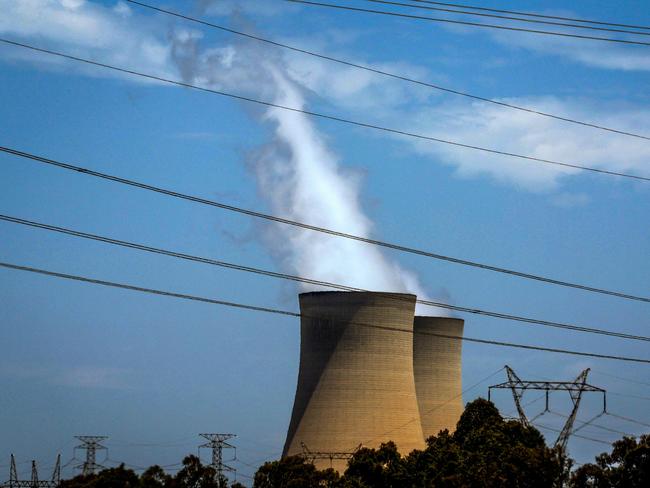 This photo taken on December 13, 2023 shows electricity lines near emission funnels for the Bayswater coal-powered thermal power station located near the central New South Wales town of Muswellbrook. (Photo by DAVID GRAY / AFP)