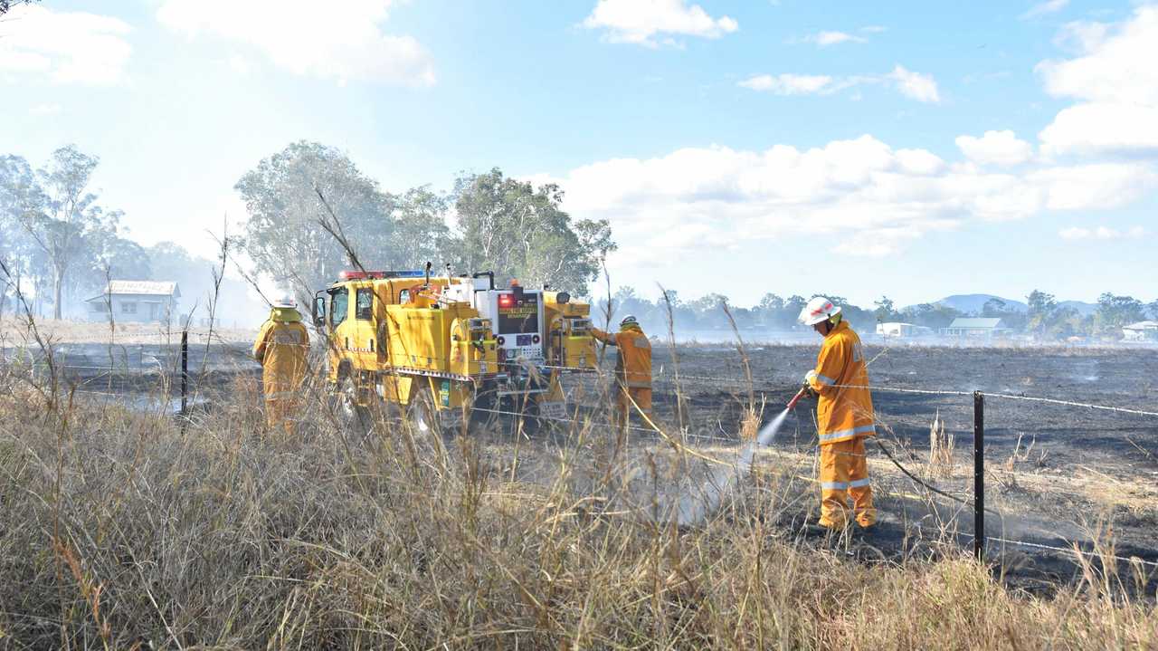 CLOSE CALL: Rural firefighters douse embers after putting out a fire at Bororen. Picture: Greg Bray