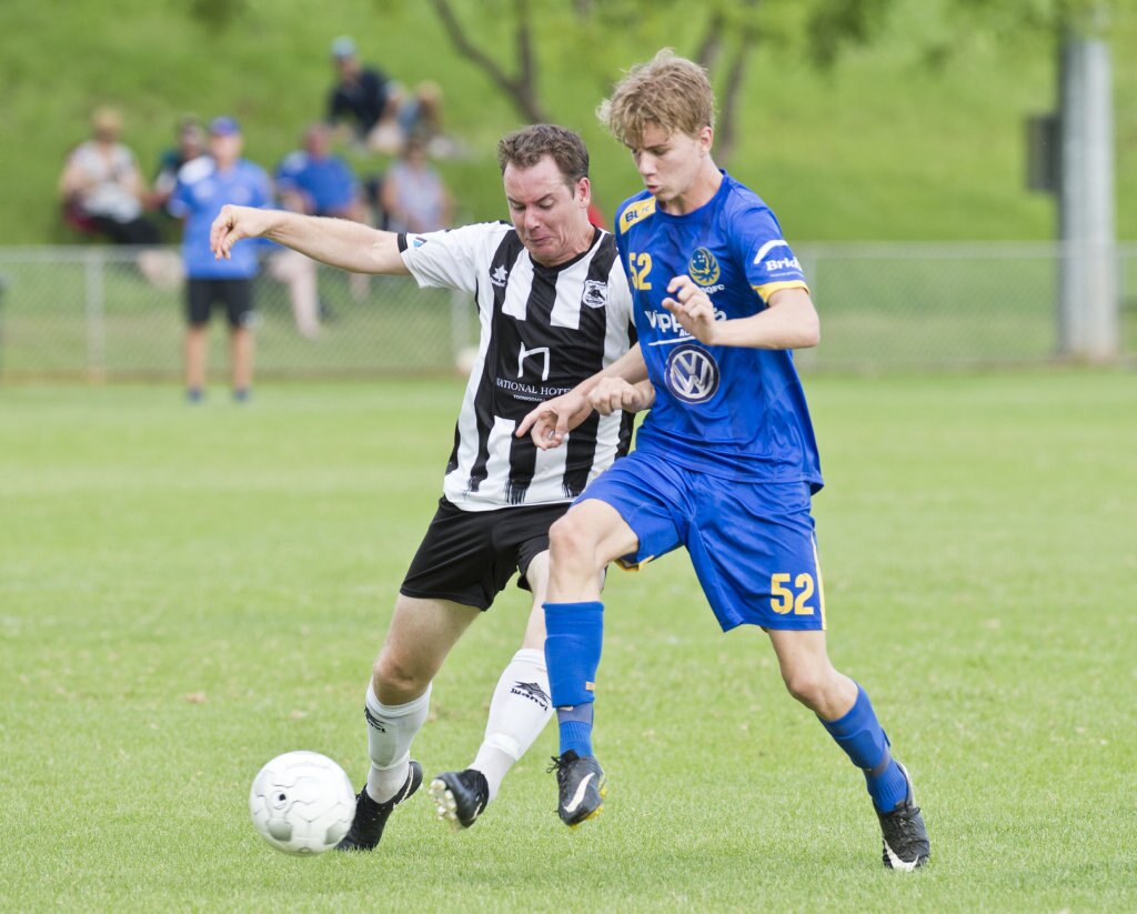 Trent Donovan, Willowburn and Cormac McCarthy, USQ. Football, Willowburn vs USQ. Sunday, 4th Mar, 2018. Picture: Nev Madsen