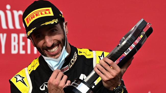 Australian driver Daniel Ricciardo holds his trophy.