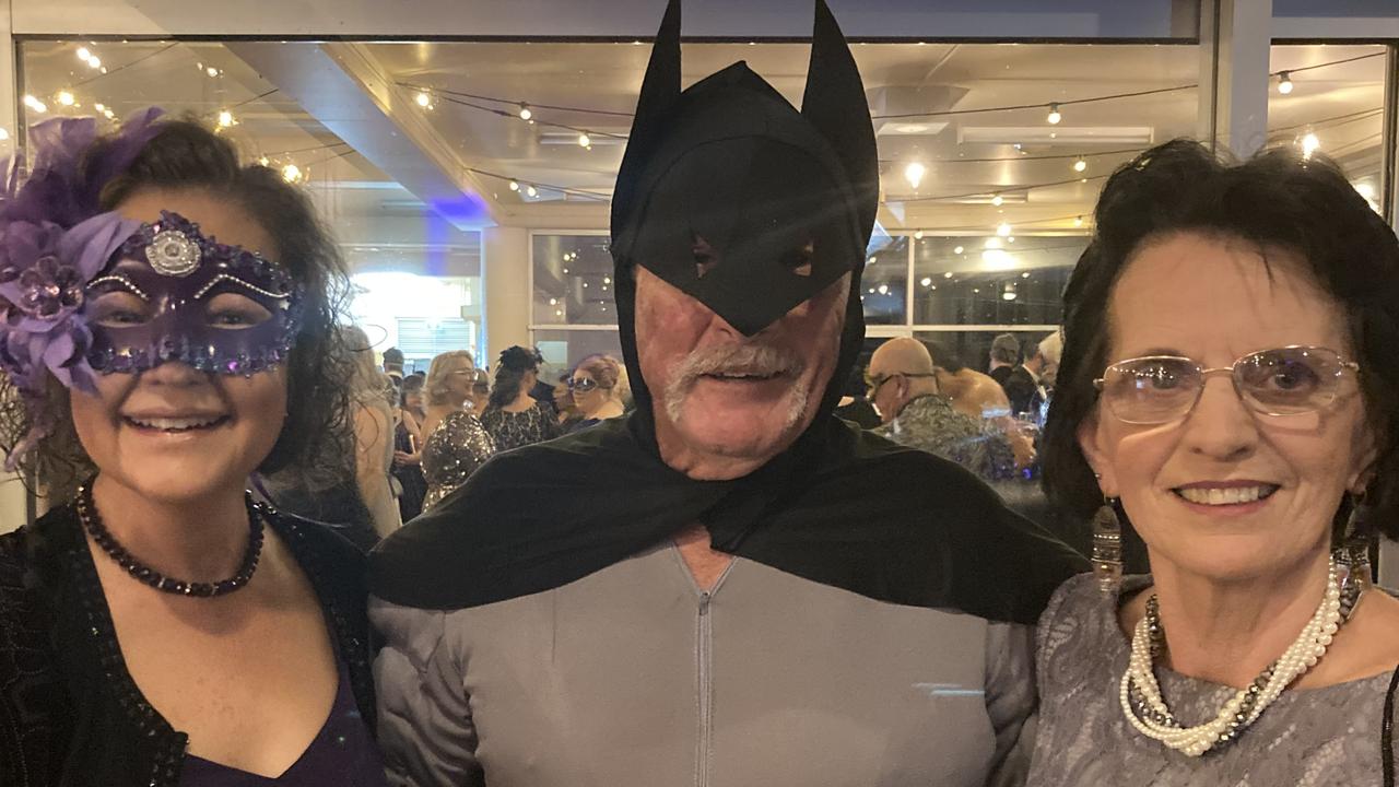 Donna Griffen, Gavin Jensen and Helen O'Brien celebrate at the Gympie RSL Masked Ball, April 29 2023.