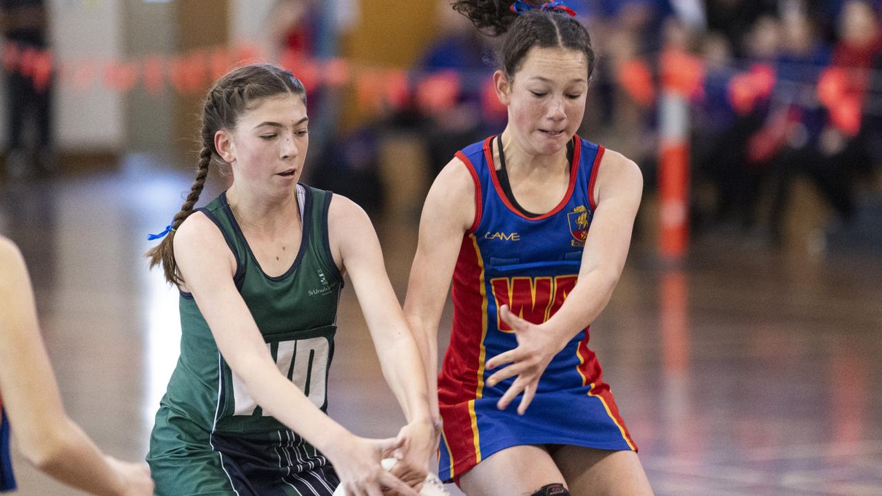 St Ursula's Junior Development player Lucy McMillan (left) competes with Latoya Challenor of Downlands Junior C in Merici-Chevalier Cup netball at Salo Centre, Friday, July 19, 2024. Picture: Kevin Farmer