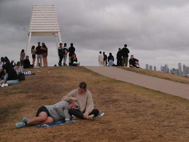 People wait for the sunrise at Point Ormond on the first day of 2025. Picture: David Crosling