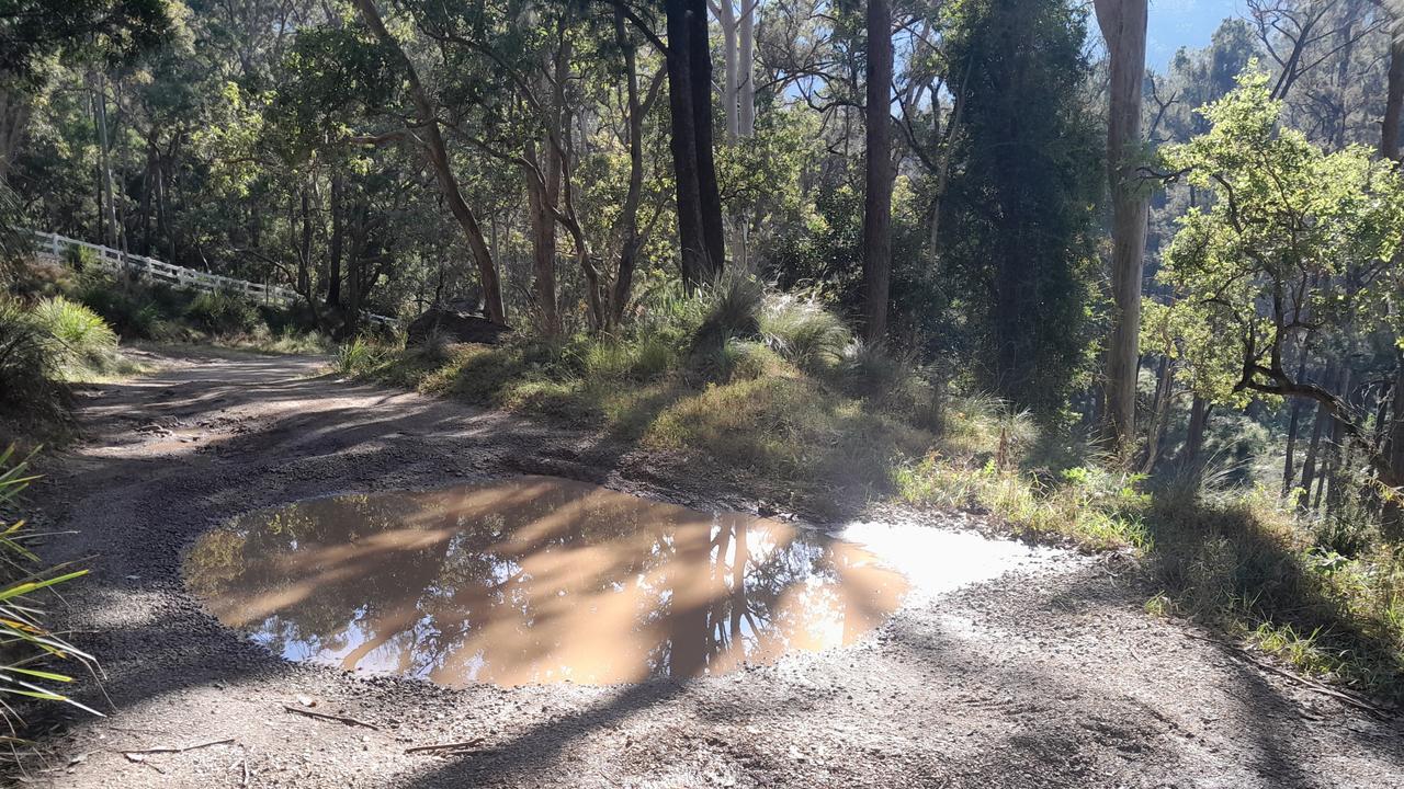 More giant potholes line the single lane of Spring Creek Rd, damaging vehicles and posing a danger to the 50-60m drop to the river below.