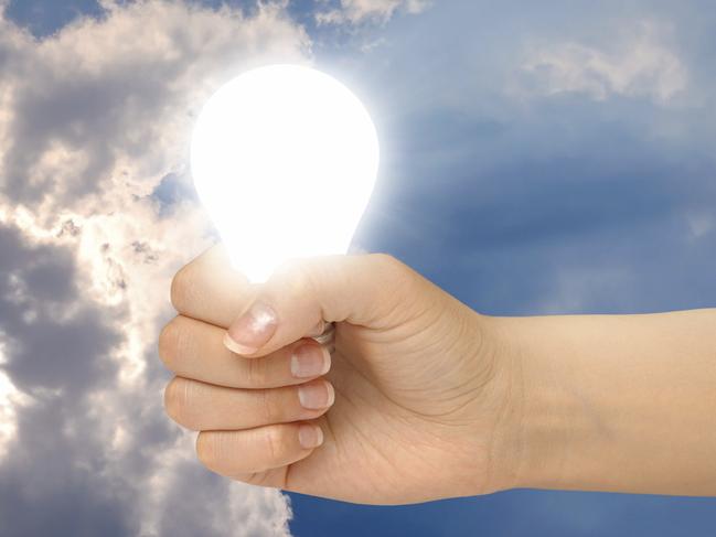 Generic image of a light bulb in a hand getting solar energy from the sun.