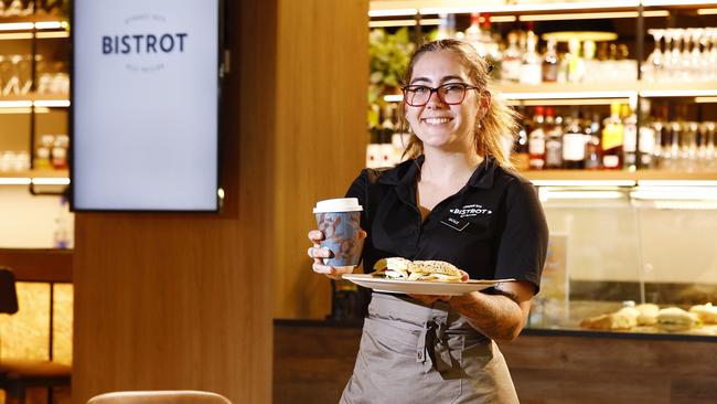 The Cairns Airport has two new eateries inside its domestic terminal, Bistrot and Two Tigers. Food and beverage supervisor of Bistrot Natalie Peacock serves up a fresh deli style sandwich and a cappuccino. Picture: Brendan Radke