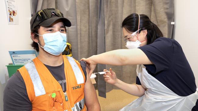 A young man receives a Covid vaccination at the Melbourne Showgrounds. Picture: David Geraghty