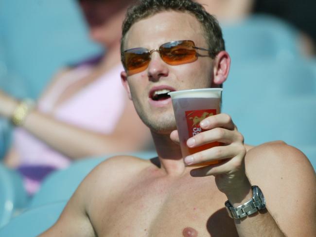 Adelaide v Kangaroos (North Melbourne). a footy fan enjoys a beer.