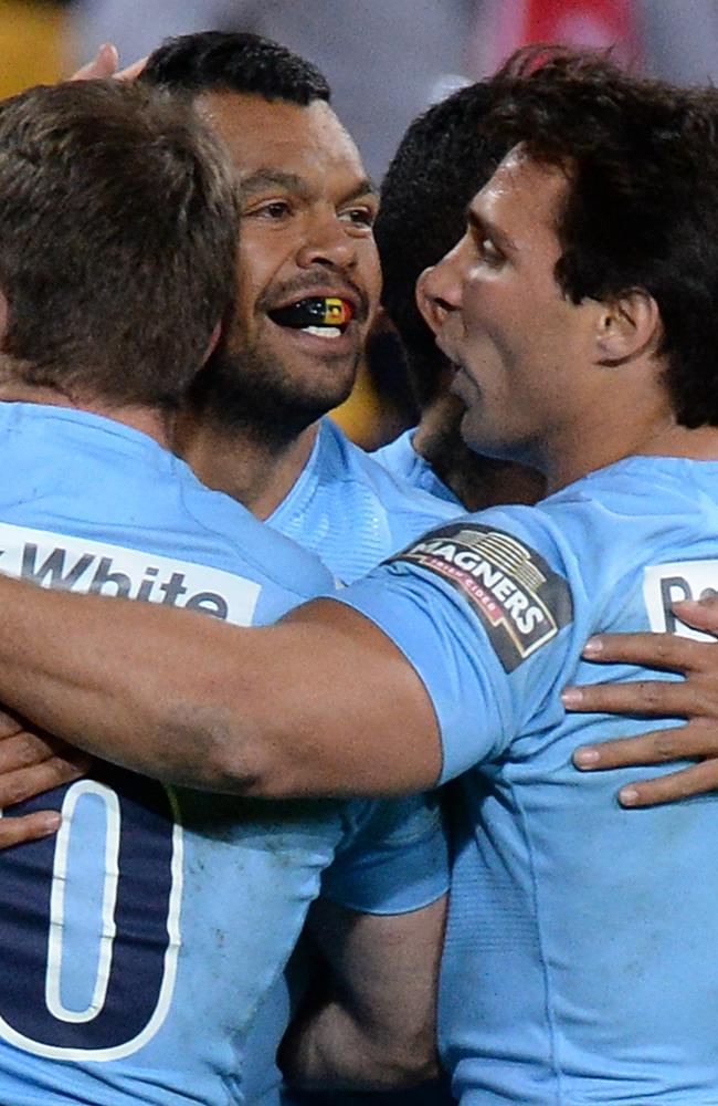 Kurtley Beale celebrates a try with his Waratahs teammates.