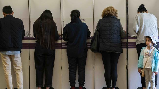 Renee Abounded 4 from Panania waiting for Mum to finish voting at Panania North Public School. Picture: Matthew Vasilescu