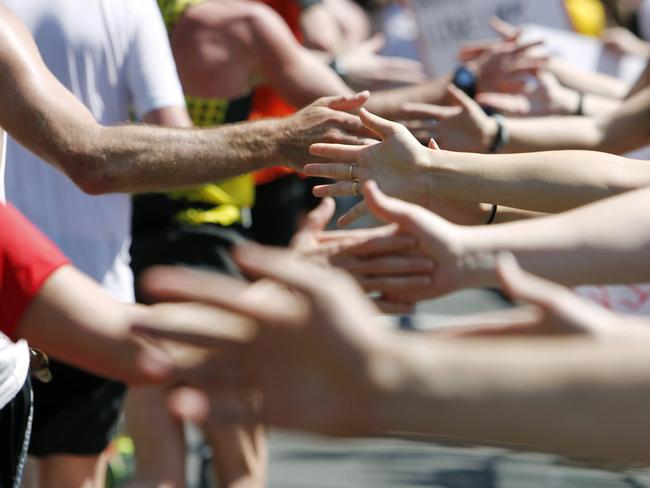 Runners pass supporters during the Boston Marathon. Picture: AP