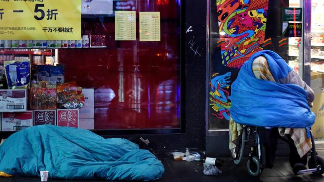 Homeless people wrap up to fight the winter chill on Russell St, Melbourne. Picture: Nicole Garmston