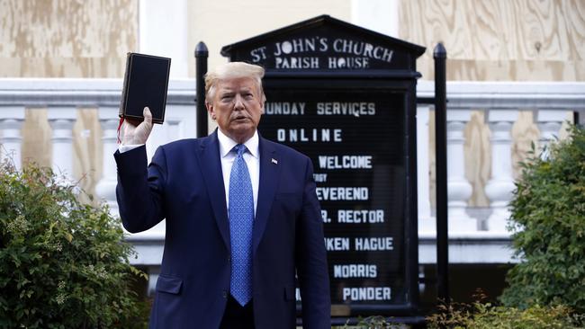 President Donald Trump holds a Bible as he visits St. John's Church at Lafayette Park across from the White House.