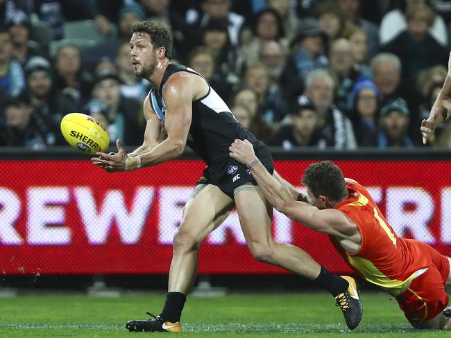 AFL - Port Adelaide v Gold Coast Suns - Round 23 - Adelaide Oval. Travis Boak gets his handpass out from Pearce Hanley. Picture Sarah Reed