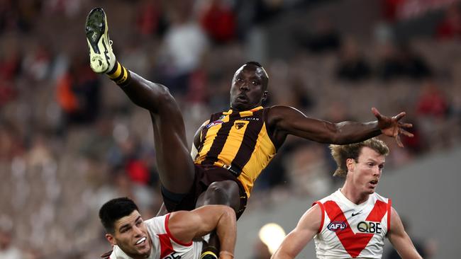 MELBOURNE, AUSTRALIA - APRIL 28: Mabior Chol of the Hawks flies for a mark over Lewis Melican of the Swans during the round seven AFL match between Hawthorn Hawks and Sydney Swans at Melbourne Cricket Ground, on April 28, 2024, in Melbourne, Australia. (Photo by Quinn Rooney/Getty Images)