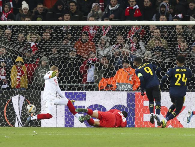Arsenal's Alexandre Lacazette, second right, scores past Liege goalkeeper Arnaud Bodart, left, the Europa League group F soccer match between Standard Liege and Arsenal at the Maurice Dufrasne stadium in Liege, Belgium, Thursday, Dec, 12, 2019. The match ended in a 2-2 draw. The match ended in a 2-2 draw. (AP Photo/Francois Walschaerts)