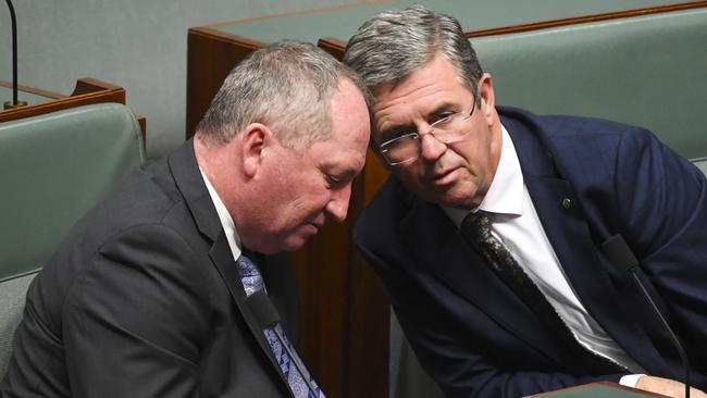 Nationals MP Barnaby Joyce speaks to party colleague David Gillespie during Question Time. Picture: AAP