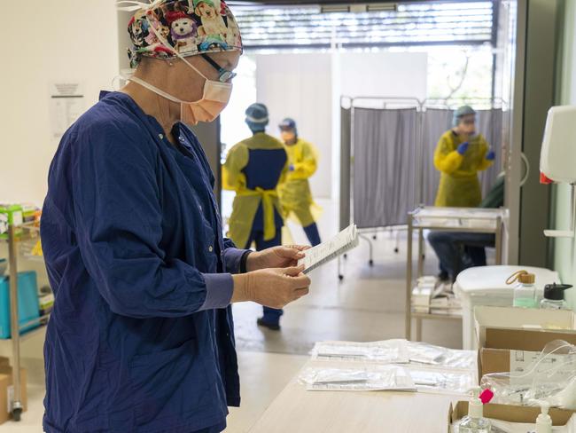 Nurse Judy Bradbury in the engine room, processing documents for patient tests. Image Matthew Vasilescu