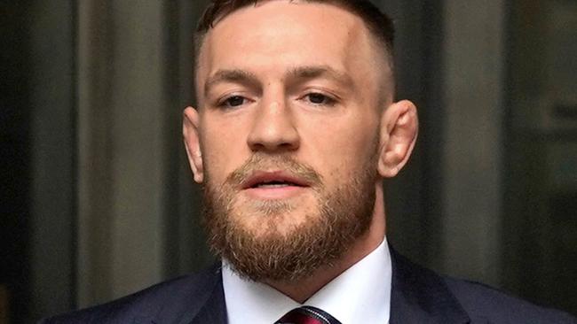 (FILES) Irish mixed martial arts fighter Conor McGregor (C) arrives to talk to the press after he pleaded guilty to a single violation of disorderly conduct in Brooklyn Criminal Court, on July 26, 2018. A woman on November 22, 2024 won civil court damages claim against mixed martial arts (MMA) fighter Conor McGregor over her allegation that he raped her in a Dublin hotel in 2018. (Photo by TIMOTHY A. CLARY / AFP)