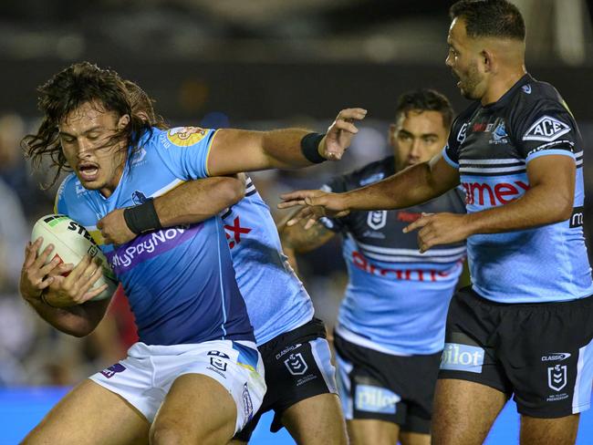 SYDNEY, AUSTRALIA - AUGUST 11: Tino Fa'asuamaleaui of the Titans is tackled during the round 24 NRL match between Cronulla Sharks and Gold Coast Titans at PointsBet Stadium on August 11, 2023 in Sydney, Australia. (Photo by Brett Hemmings/Getty Images)