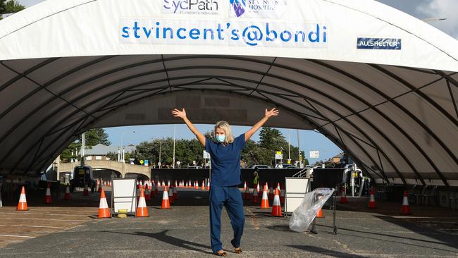 Nurse Francie celebrates at sunrise on New Years Day at the Covid-19 drive thru testing site at Bondi Beach. Picture: Newscorp Daily Telegraph / Gaye Gerard