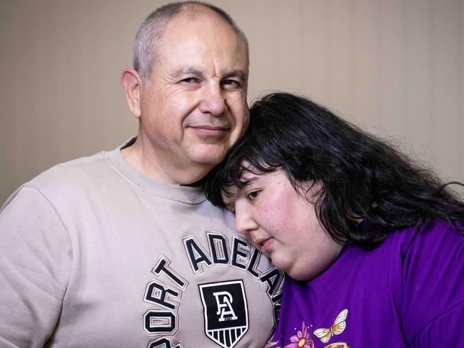 August 19, 2024: Georgia Kosteriadis with her dad Alex Kosteriadis at their home in seaton. They are on the verge of being evicted and bankruptcy after the NDIS cut two-thirds of their daughters funding against the advice of doctors. Picture: Kelly Barnes