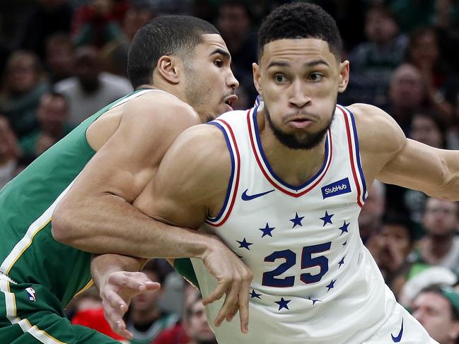 Philadelphia 76ers' Ben Simmons (25) drives past Boston Celtics' Jayson Tatum during the second half of an NBA basketball game in Boston, Tuesday, Dec. 25, 2018. (AP Photo/Michael Dwyer)