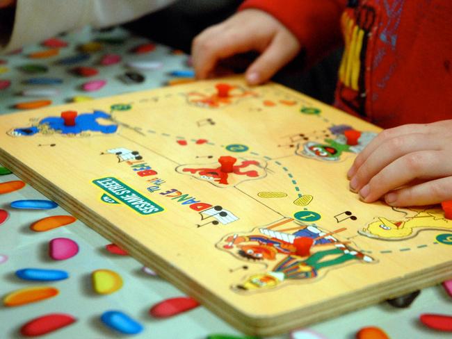 Undated : Young child at at Child Care Centre playing with a Sesame Street jigsaw puzzle.