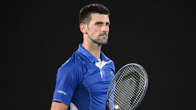 TOPSHOT - Serbia's Novak Djokovic celebrates after victory against Argentina's Tomas Etcheverry during their men's singles match on day six of the Australian Open tennis tournament in Melbourne on January 19, 2024. (Photo by WILLIAM WEST / AFP) / -- IMAGE RESTRICTED TO EDITORIAL USE - STRICTLY NO COMMERCIAL USE --