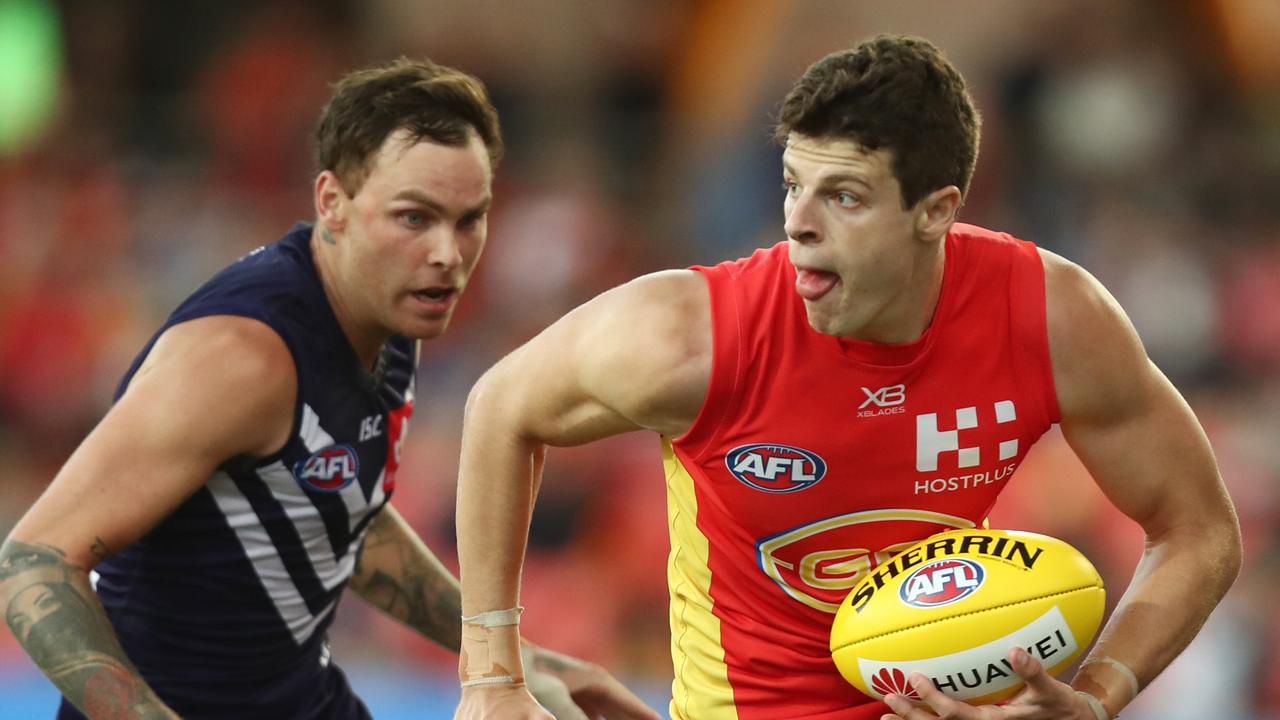 GOLD COAST, AUSTRALIA – MARCH 31: Chris Burgess of the Suns runs the ball during the round two AFL match between the Gold Coast Suns and the Fremantle Dockers at Metricon Stadium on March 31, 2019 in Gold Coast, Australia. (Photo by Chris Hyde/Getty Images)