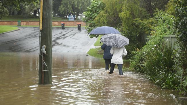 Residents of North st Windsor are forced to wade through sewage mixed with flooding. Picture:John Grainger