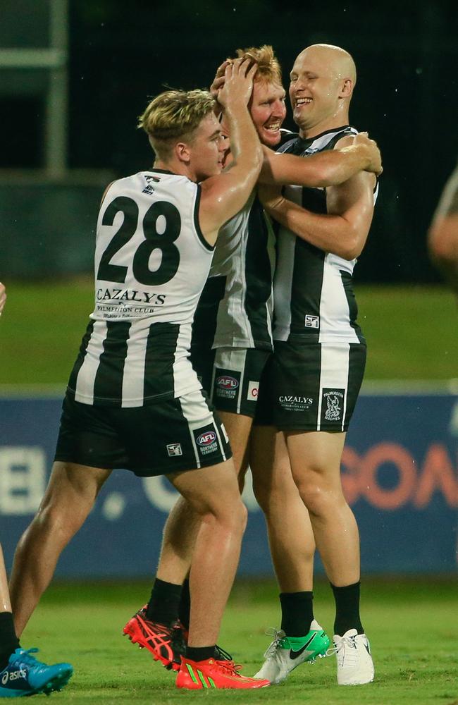 Gary Ablett Jr and Baxter Mensch congratulate Eric Guthrie as Palmerston play St Mary’s.. Picture: Glenn Campbell