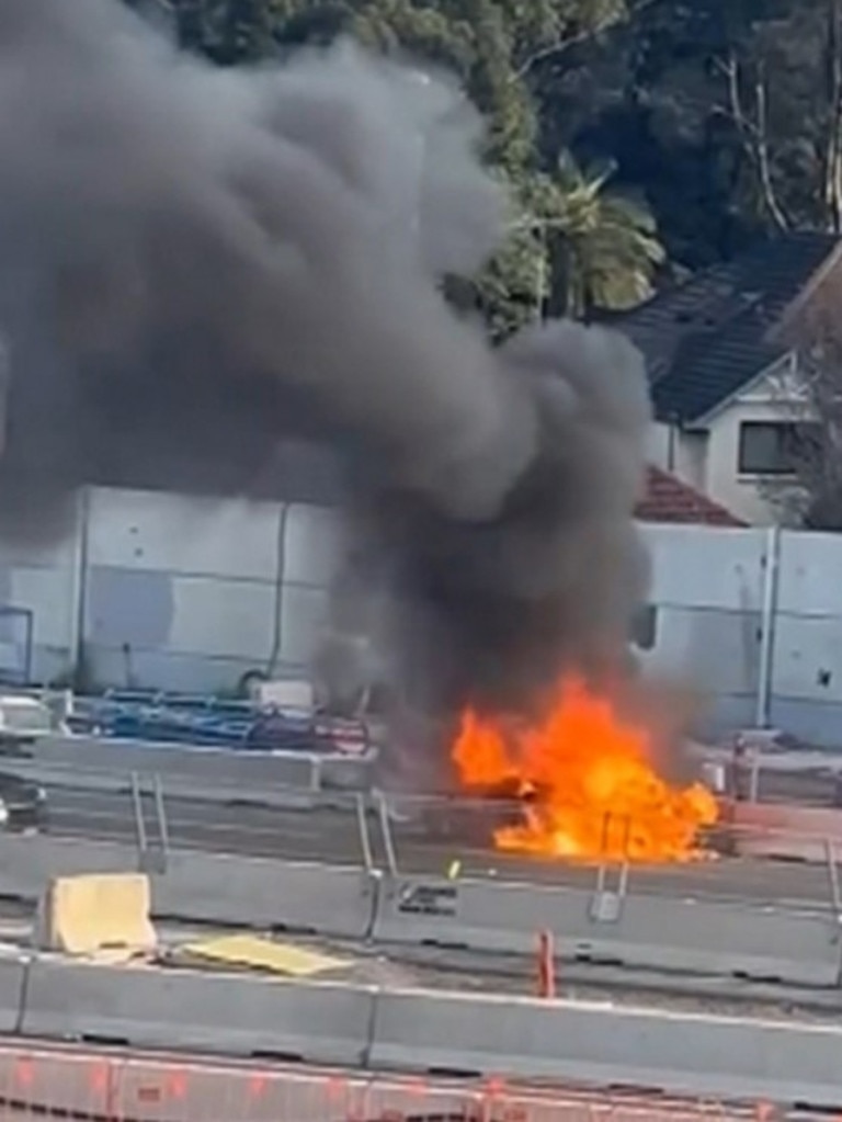 A car caught alight on the Warringah Fwy, closing two of three northbound lanes. Credit: 7NEWS