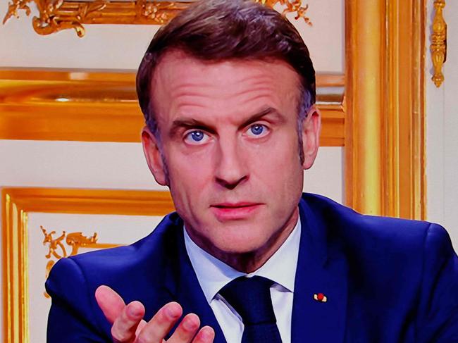 French President Emmanuel Macron is seen on monitors along with sutitles which read "I will name a new Prime Minister in the coming days", in a control room at AFP headquarters as he addresses the nation during a televised broadcast from the presidential Elysee Palace, on the day of the Prime Minister's resignation on December 5, 2024, following the parliamentary defeat one day prior, that forced his government to step down. President Emmanuel Macron on December 5, 2024, sought a new prime minister to prevent France from sliding deeper into political turmoil after Prime Minister's government was ousted in a historic no-confidence vote in parliament. The vote was the first successful no-confidence action since a defeat for Georges Pompidou's government in 1962, when Charles de Gaulle was president. (Photo by Ludovic MARIN / AFP)