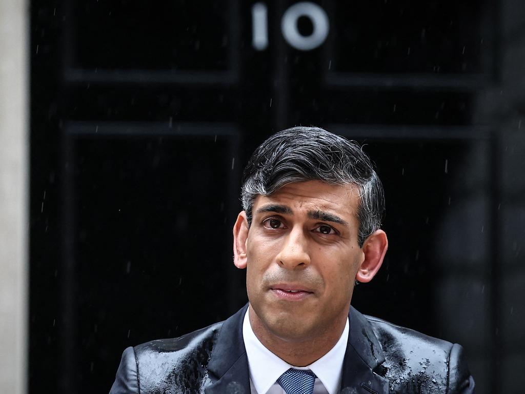 Britain's Prime Minister Rishi Sunak, soaked in rain, pauses as he delivers a speech to announce July 4 as the date of the UK's next general election, at 10 Downing Street. Picture: AFP