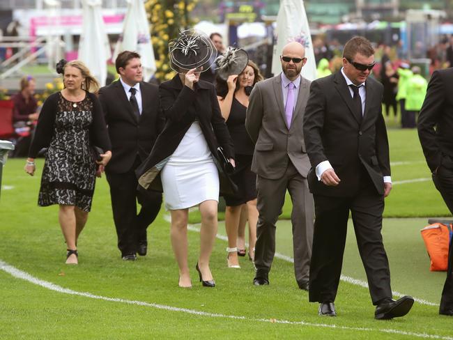 Crowds arriving in cool conditions on Victoria Derby Day at Flemington Racecourse on Saturday, November 1, 2014, in Flemington, Australia. Picture: Hamish Blair