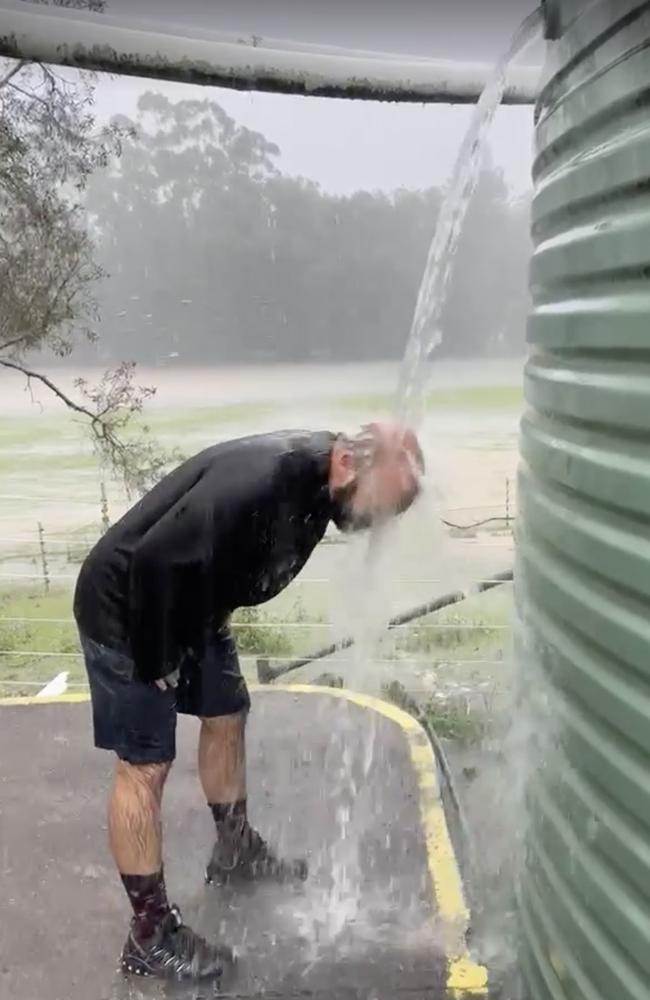 David Simon of Nambour shows how you take a shower now after extreme flooding on the Sunshine Coast.