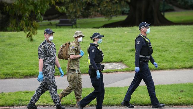 Police and ADF on patrol in the Fitzroy Gardens. Picture: Ian Currie/NCA NewsWire.