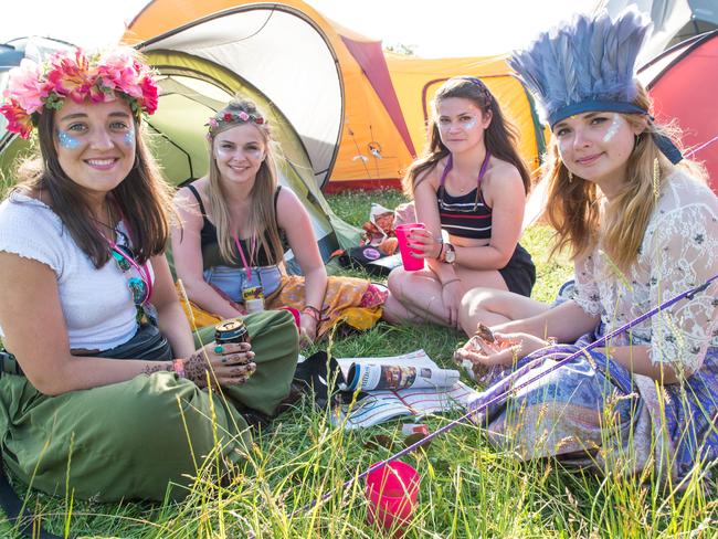 Besties: Friends outside their tent on day one of the festival which will be headlined by Kanye West and Florence and the Machine. Picture: Ian Gavan/Getty Images.