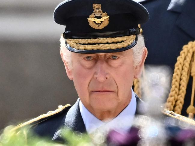 (FILES) In this file photo taken on September 14, 2022 Britain's King Charles III walks behind the coffin of Queen Elizabeth II, adorned with a Royal Standard and the Imperial State Crown and pulled by a Gun Carriage of The King's Troop Royal Horse Artillery, during a procession from Buckingham Palace to the Palace of Westminster, in London. - The coronation of King Charles III will take place on May 6, 2023, Buckingham Palace announced on October 11, 2022, vowing to reflect the monarchy's historic traditions and its modern role. Charles, 73, will be formally crowned at London's Westminster Abbey, following a long tradition dating back more than 900 years. (Photo by Marco BERTORELLO / AFP)