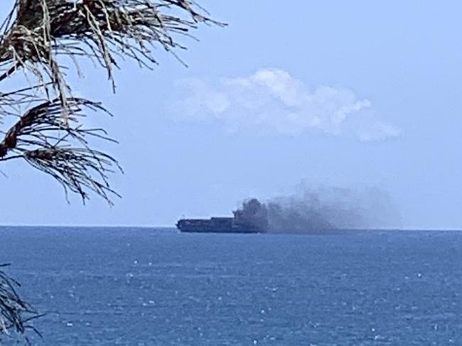 A dramatic picture shows smoke from a cargo ship after it had mechanical difficulty off Moffat Beach on October 12. Picture: Contributed