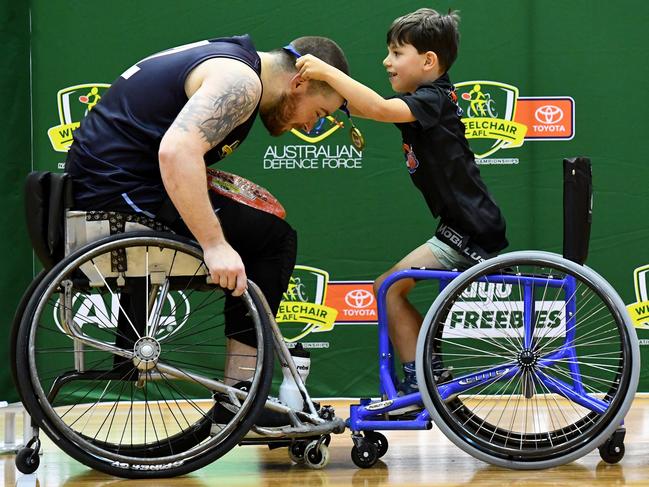 Nick Briant of Victoria Metro is presented with his premiership medal after winning the Division 1 Grand Final match at the 2023 Toyota AFL Wheelchair National Championships. Picture: Josh Chadwick/AFL/Getty Images