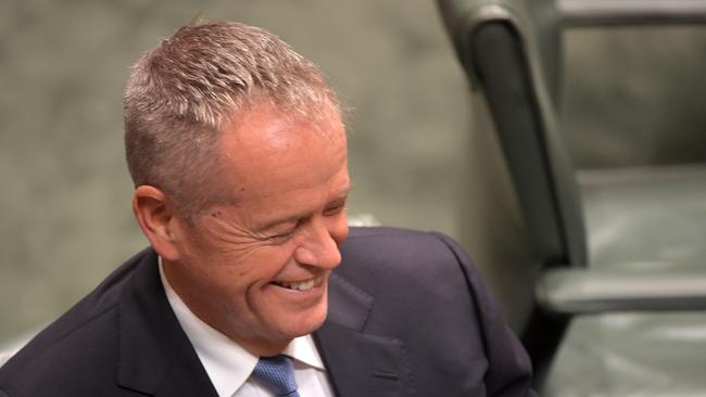 Opposition Leader Bill Shorten smiles while listening to Treasurer Josh Frydenberg deliver the budget. Picture: Getty