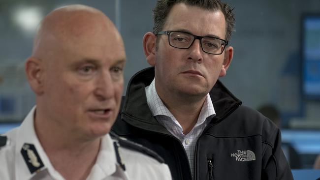 Victoria’s Emergency Management Commissioner Craig Lapsley and Victorian Premier Daniel Andrews talk on Saturday. Picture: AAP Image/Luis Enrique Ascui.