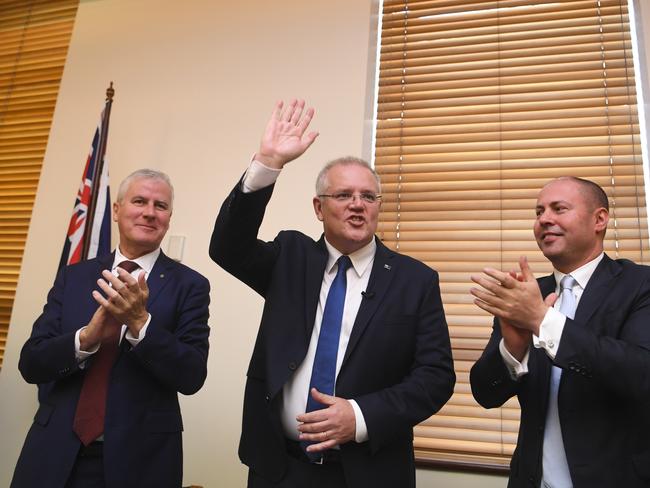 (L-R) Australian Deputy Prime Minister Michael McCormack, Australian Prime Minister Scott Morrison and Federal Treasurer Josh Frydenberg react during a Coalition party room meeting at Parliament House in Canberra, Tuesday, May 28, 2019. (AAP Image/Lukas Coch) NO ARCHIVING