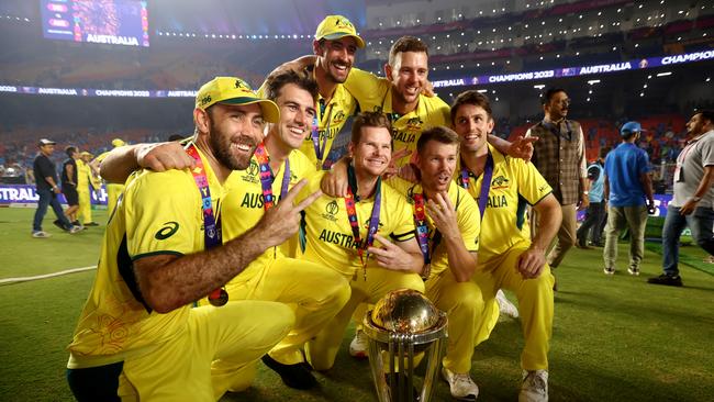 AHMEDABAD, INDIA - NOVEMBER 19: Glenn Maxwell, Pat Cummins, Steve Smith, David Warner, Mitchell Starc, Josh Hazlewood and Mitch Marsh of Australia pose with the ICC Men's Cricket World Cup following the ICC Men's Cricket World Cup India 2023 Final between India and Australia at Narendra Modi Stadium on November 19, 2023 in Ahmedabad, India. (Photo by Robert Cianflone/Getty Images)